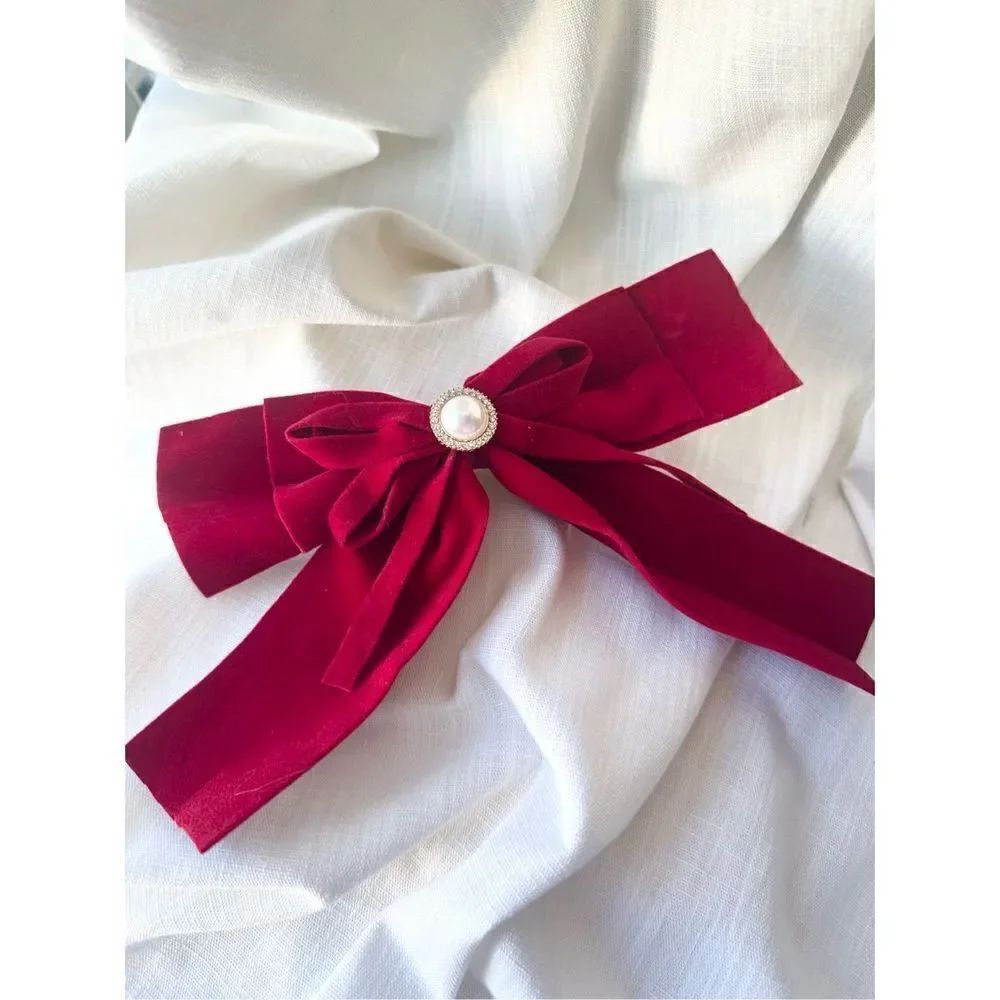 Christmas red pearl button hair bow with rhinestone accents. French clip close.